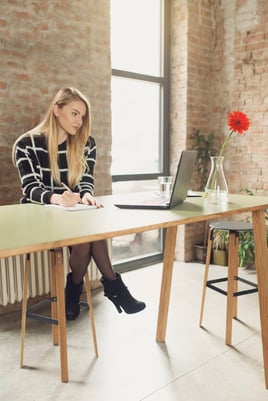 Mompreneur working in her office on the computer with intentional focus.