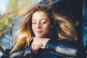 Woman reveling in inner peace while enjoying a gentle breeze